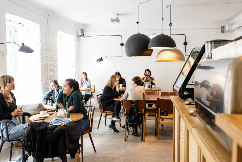 Group of diverse friends sitting in modern cafe